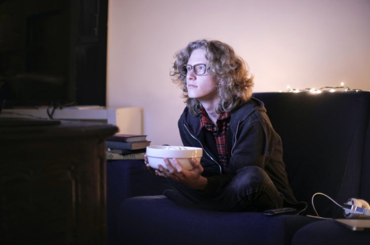 a young adult watching tv