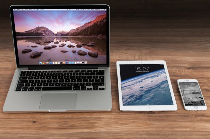 three apple products sitting on a table