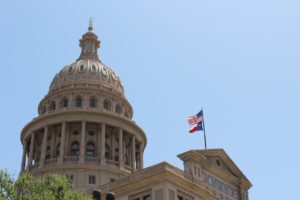 Texas state capitol in Austin Texas with the American flag flying