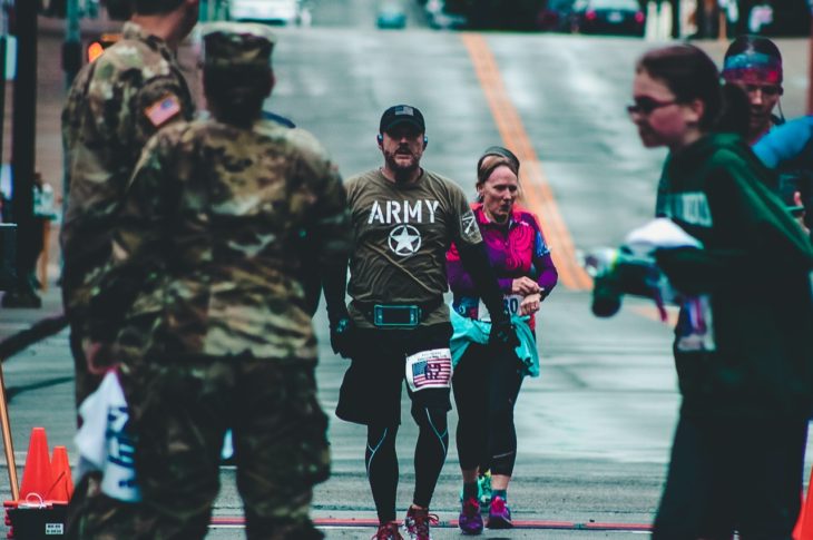 man walking down the street in a army t-shirt