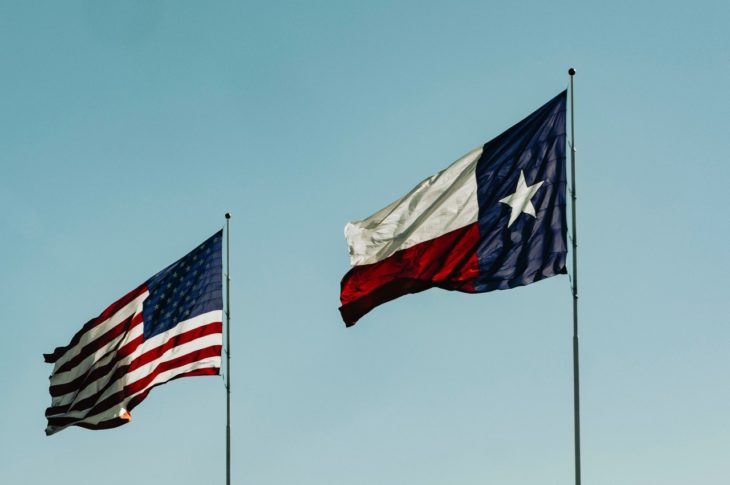 Texas flag flying next to the U.S. flag
